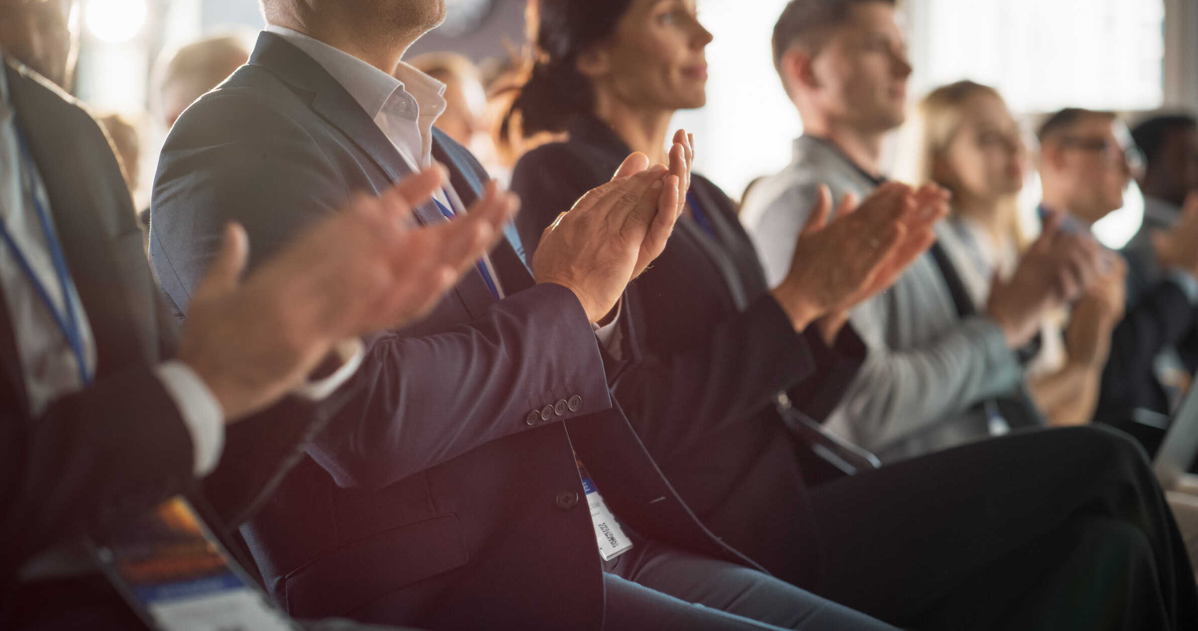 Close Up on Hands of Audience Applauding in Concert Hall During Business Forum Presentation. Technology Summit Auditorium Room With Corporate Delegates. Excited Entrepreneurs Clapping.